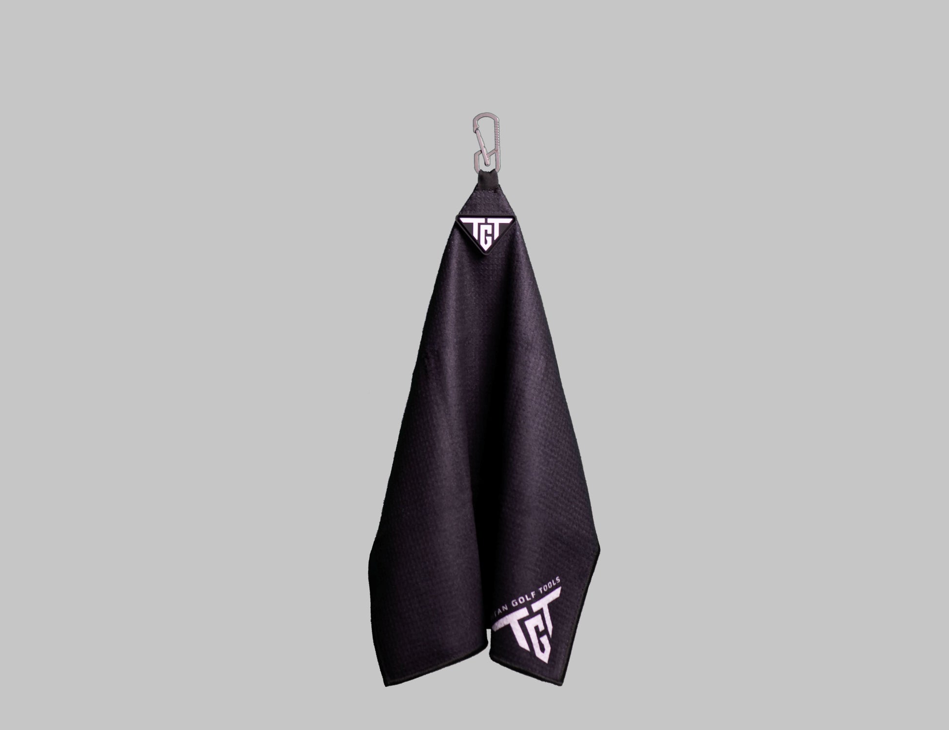 Ti TOWEL premium microfiber golf towel with titanium carabiner
hanging on bag